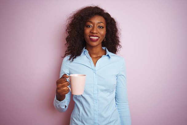 Young african american woman drinking cup of coffee over isolated pink background with a happy face standing and smiling with a confident smile showing teeth - Φωτογραφία, εικόνα