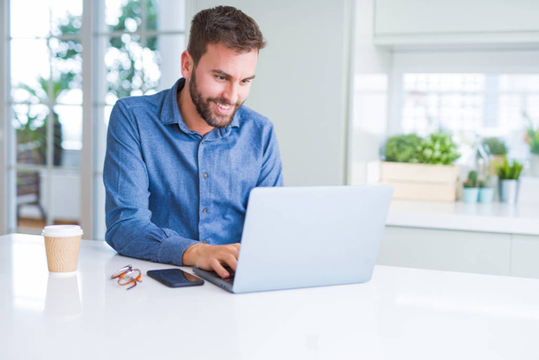 Handsome business man working using computer laptop and smiling - Foto, imagen