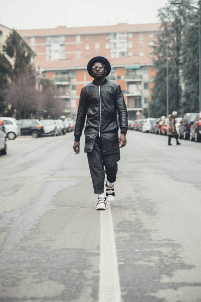 young black man walking in the street and looking camera  - Fotó, kép