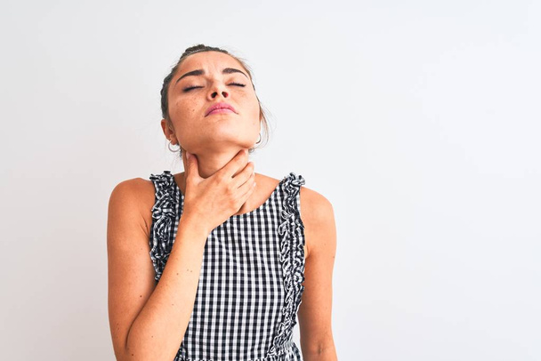Beautiful woman with bun wearing casual dresss standing over isolated white background Touching painful neck, sore throat for flu, clod and infection - Photo, Image