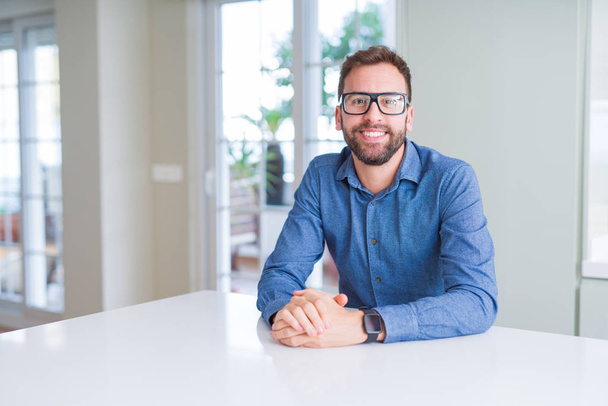 Handsome man wearing glasses and smiling relaxed at camera - Foto, Bild