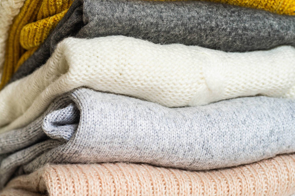 Fall Background with warm sweaters. Pile of knitted clothes. Warm background, knitwear - Fotó, kép
