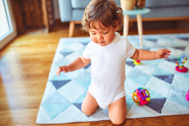 Beautiful toddler child girl playing with toys on the carpet - Photo, Image