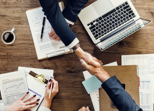 Business people shaking hands, finishing up a meeting. stock photo - Fotó, kép