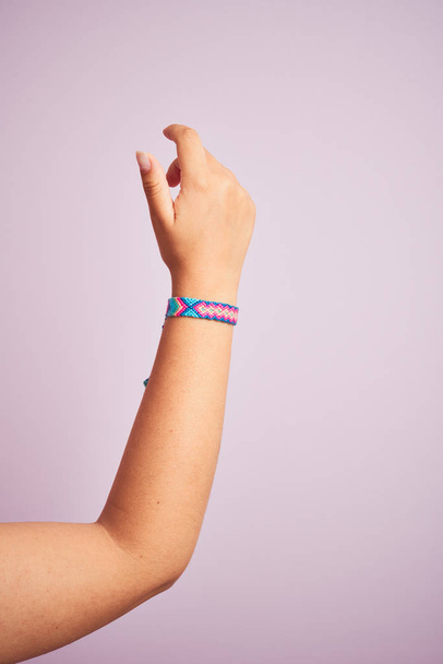 Arm of model woman with beautiful handmade colorful bracelet on wrist - Fotografie, Obrázek