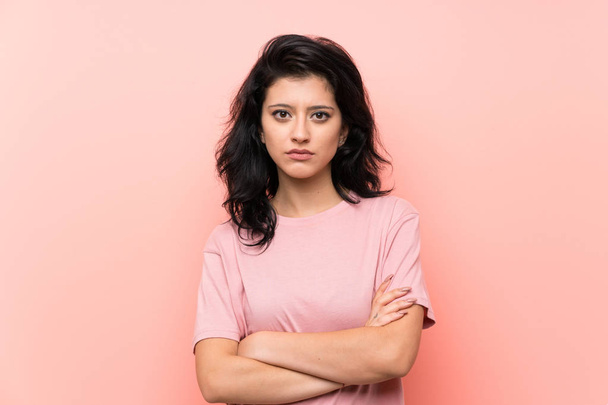 Young woman over isolated pink background keeping arms crossed - Φωτογραφία, εικόνα