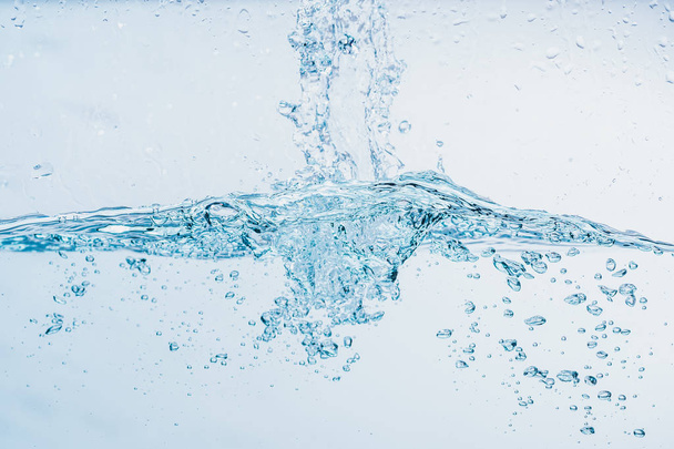 Woda rozpryskania bliska Splash wody tworząc kształt izolowane na białym tle. - Zdjęcie, obraz