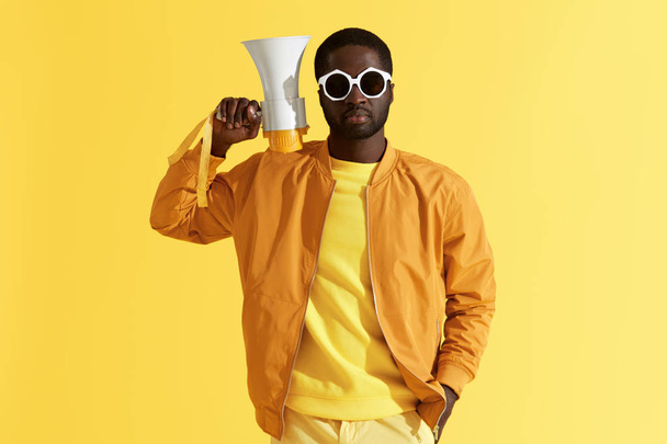 Black man in fashion sunglasses with megaphone portrait  - Фото, изображение