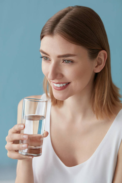 Drink water. Smiling woman drinking water from glass portrait - Zdjęcie, obraz