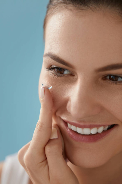 Eye care. Smiling woman with contact eye lens on finger closeup - Φωτογραφία, εικόνα