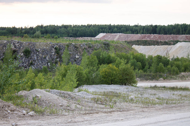 An old abandoned limestone quarry in Russia at sunset on a summer evening - Foto, imagen
