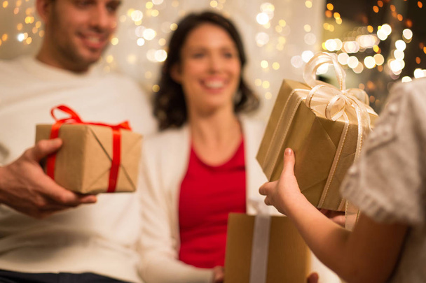 close up of family with christmas gifts at home - Фото, изображение