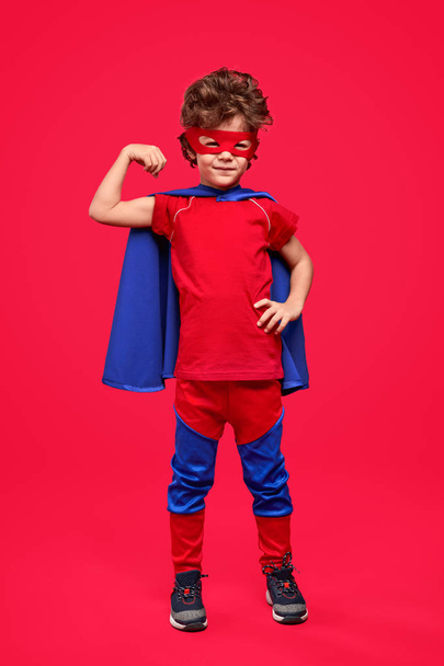 Little superhero showing arm muscles - Фото, зображення