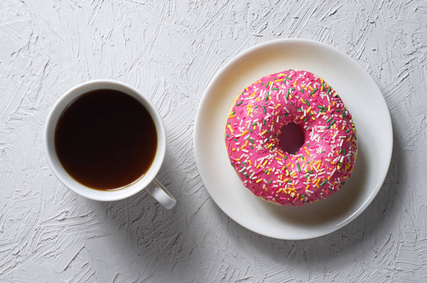 Donut with colorful icing and coffee - Photo, image