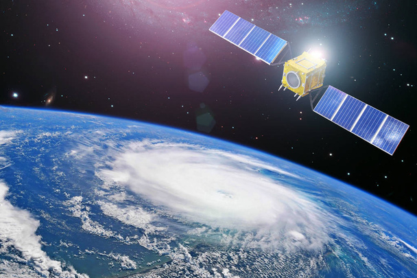 Monitoring hurricane. Satellite above the Earth makes measurements of the weather parameters and movement trajectory. Elements of this image furnished by NASA. - Photo, Image