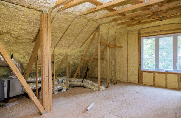 Foam plastic insulation installed in the sloping attic of new frame house. - Photo, Image
