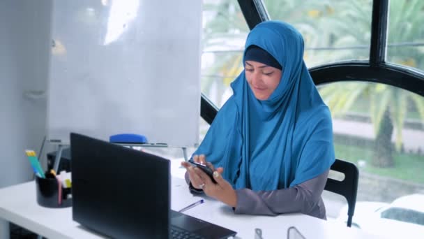 beautiful saudi business woman in hijab working in office using laptop, copy space - Felvétel, videó