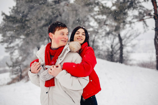 Loving couple walking in a winter park - Фото, изображение