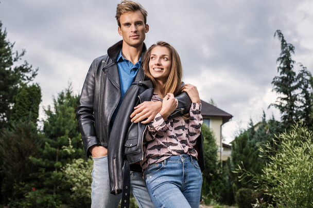 Young beautiful couple in garden near house. - Photo, image