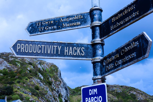 Word writing text Productivity Hacks. Business concept for tricks that you get more done in the same amount of time Road sign on the crossroads with blue cloudy sky in the background. - Photo, Image