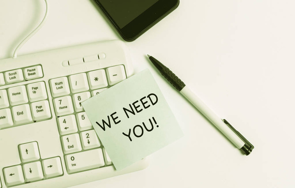 Handwriting text writing We Need You. Concept meaning asking someone to work together for certain job or target White pc keyboard with empty note paper above white background. - Photo, Image