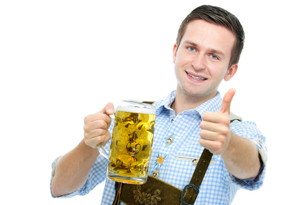 young mqan with a Oktoberfest beer stein - Фото, изображение