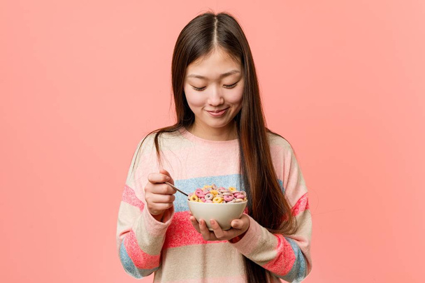 Young asian woman holding a cereal bowl - Photo, Image