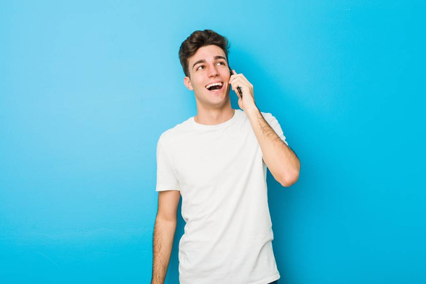 Teenager caucasian man talking on the phone - Fotó, kép