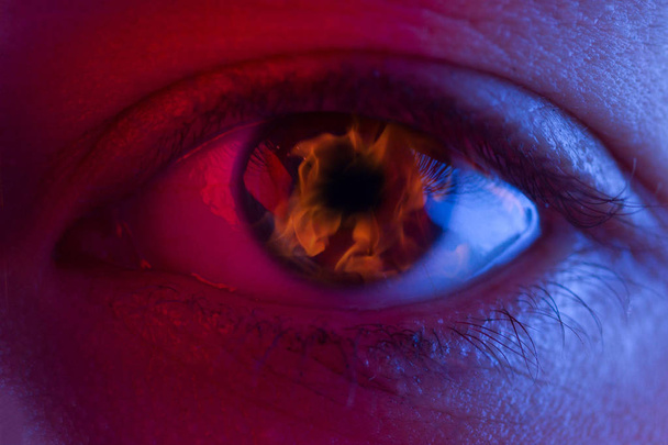 Flame in woman eye - Foto, imagen