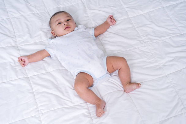cheerful baby on a bed - Fotó, kép