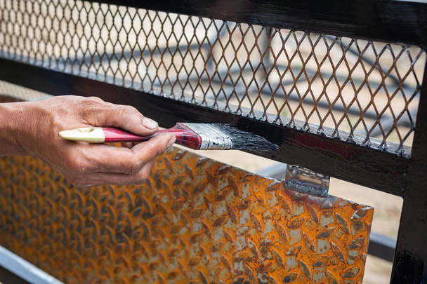 Workers use black steel paint brushes. - Foto, Imagem