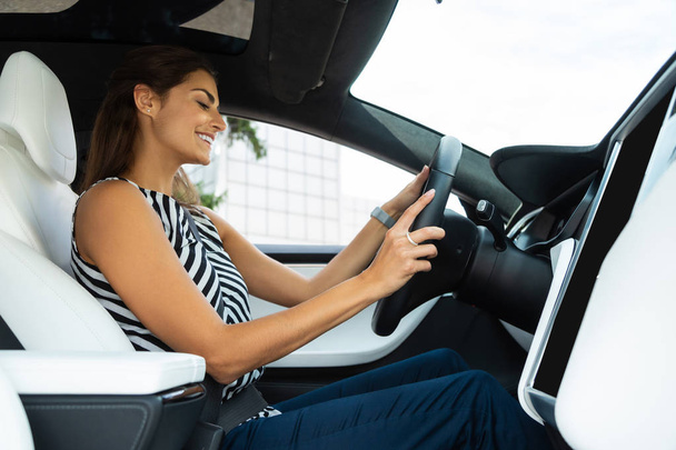Young woman wearing stylish blouse feeling good while driving - Фото, зображення