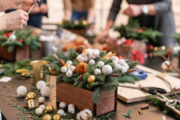Master class on making decorative ornaments. Flower shop. Christmas decor with their own hands. Woman created a xmas arrangement. - Photo, Image