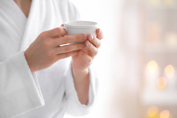 Young man in bathrobe drinking coffee at home, closeup - Photo, Image