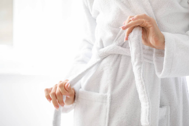 Beautiful young woman in bathrobe at home, closeup - Zdjęcie, obraz