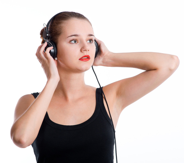 Young woman with headphones listening music - Foto, imagen