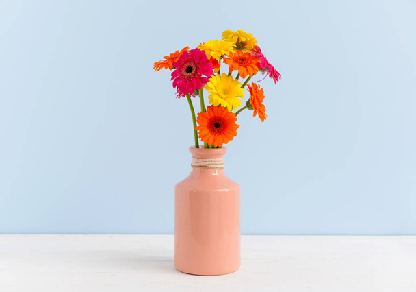 Vase with beautiful gerbera flowers on table - Foto, afbeelding