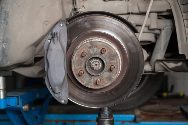 A close-up on the brake system of a car with pads, discs, a cali - Photo, Image