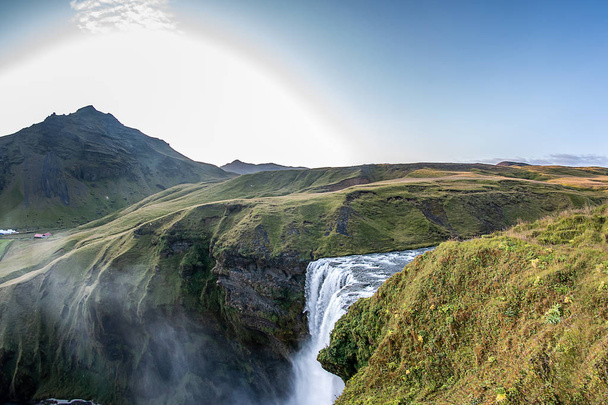 Skogafoss. The waterfall in Iceland is amazing. It is worth going upstairs over more than 500 steep stairs - Фото, изображение