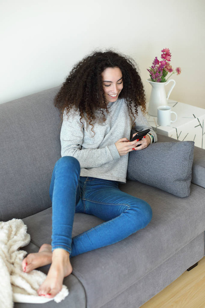 Relaxed girl at home using smartphone - Foto, Imagem