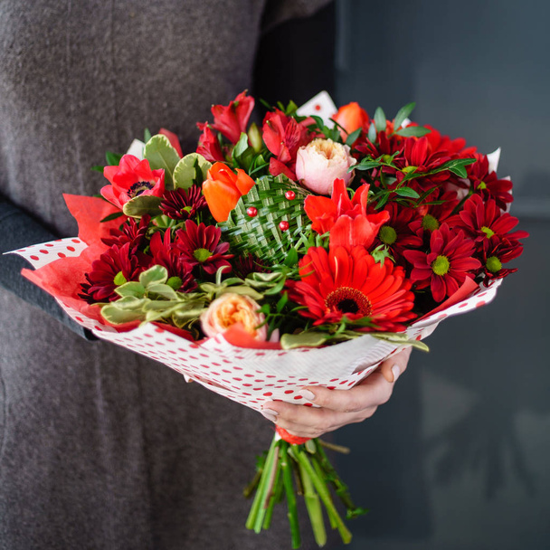 woman holding nice bouquet of flowers - 写真・画像