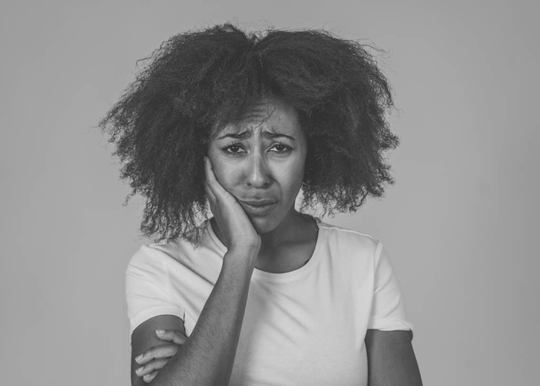 Portrait of african american woman in pain with sad and exhausted face looking concerned, worried and thoughtful in human emotions Mental health and Depression. Isolated on neutral background. - Photo, image
