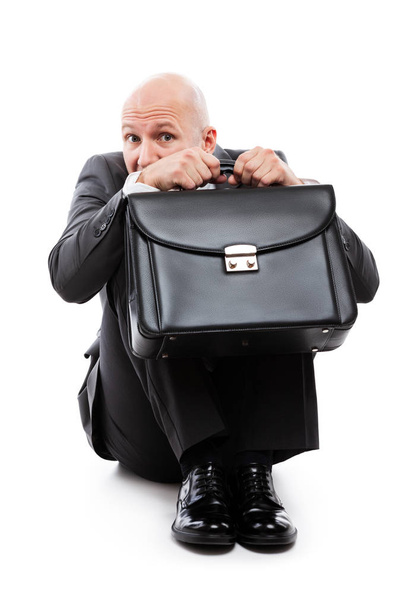 Unhappy scared or terrified businessman in depression hand holding briefcase - Photo, image