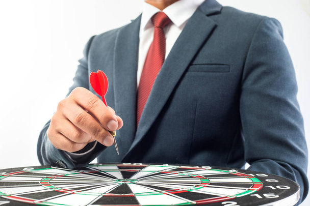 Business Man hand holding a target with darts hitting the center - Photo, Image