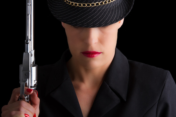 Dangerous woman in black with silver handgun - Foto, afbeelding