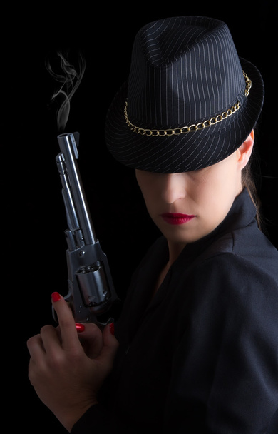 Dangerous woman in black with silver smoking handgun - Foto, Bild