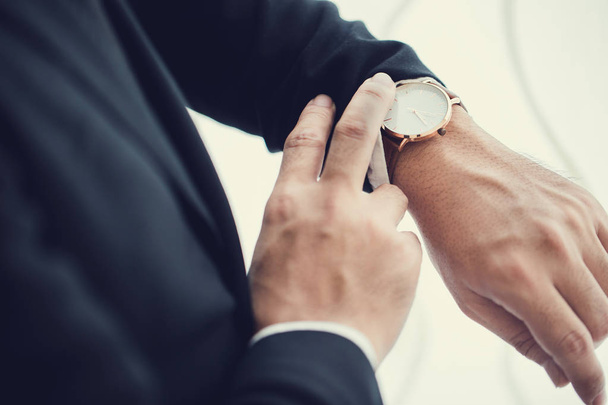 Businessman looking at his watch in office - Foto, immagini