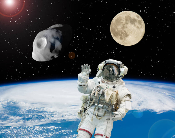 Astronauts flying in outer space. Moon on the backdrop. Space sc - Photo, Image