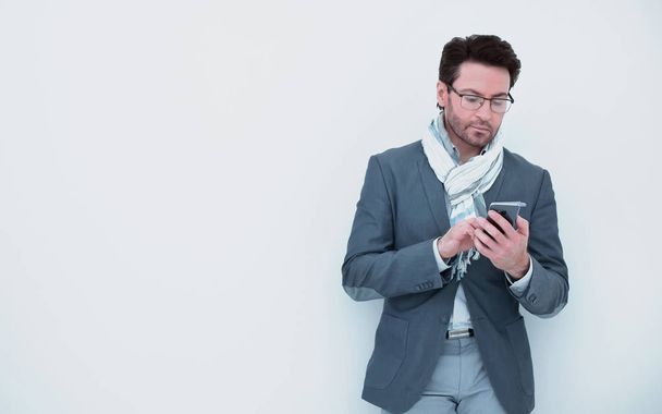 businessman with scarf on neck typing SMS on smartphone. - Φωτογραφία, εικόνα