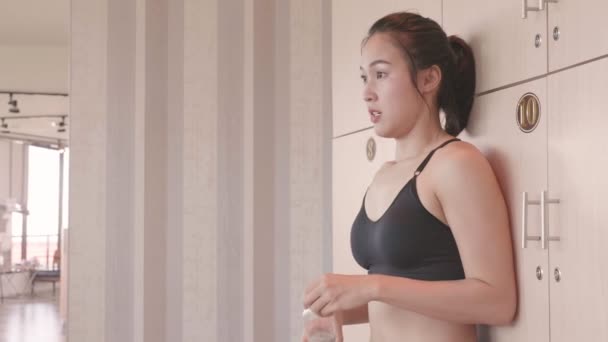beautiful Asian woman relaxing in gym after training - Felvétel, videó
